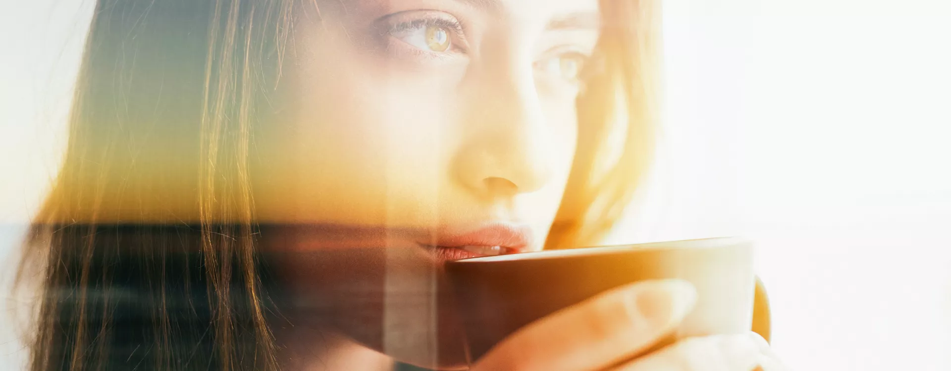 Femme contemplative, tenant une tasse, superposée à un paysage au coucher du soleil, créant une ambiance mélancolique et sereine.
